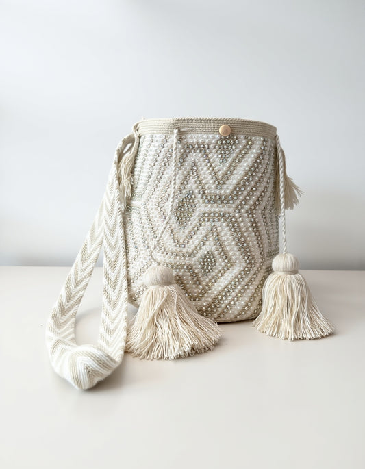 Mochila de lujo con tejido perlado, ideal para looks neutros y sofisticados.